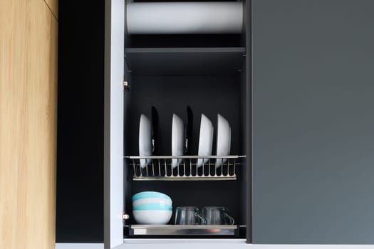 This contemporary kitchen cabinet beautifully showcases a neatly arranged collection of plates and glasses