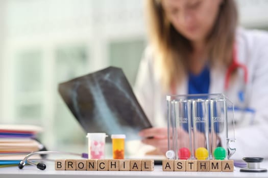 A skilled healthcare professional is meticulously analyzing bronchial asthma by using Xray and various lab tools