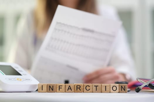 A skilled healthcare professional is systematically analyzing critical infarction data using advanced medical equipment