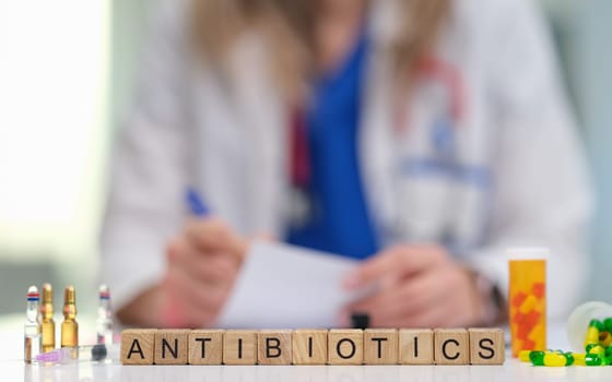 A doctor who is prescribing antibiotics is emphasizing their critical role in effective patient care and overall health