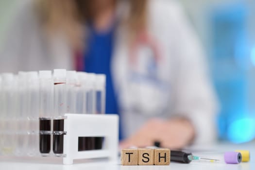 A qualified medical professional is carefully examining blood samples for TSH testing in a specialized laboratory