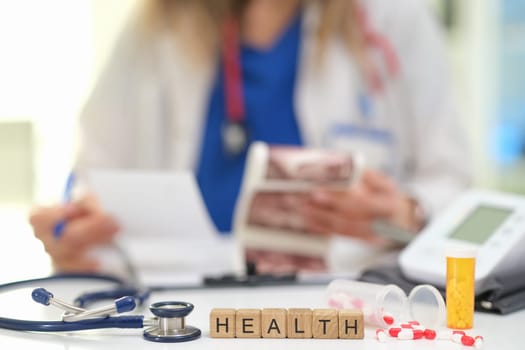 A healthcare professional examines patient information and healthrelated items for care and treatment