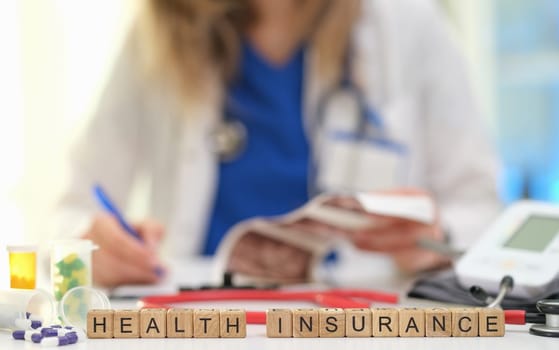 A healthcare professional thoroughly discussing various health insurance options with patients to provide clarity