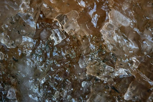 A close-up macro photography capturing the shiny facets of a smoky crystal texture cluster of potash fertilizer, revealing its complex structure, background.