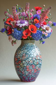 A vibrant combination of beautiful flowers arranged in a stunning, intricately designed vase, ideal for decoration