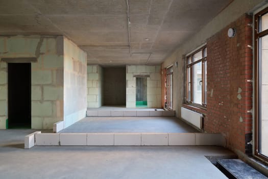 The spacious unfinished interior showcases various aspects of contemporary architecture and unique design elements