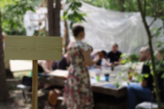 A vibrant outdoor gathering filled with people actively engaged in fascinating conversations amidst beautiful nature