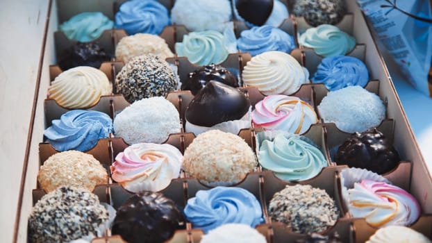 Delicious marshmallows and chocolate cakes arranged in a wooden box, creating a tempting display of sweetness