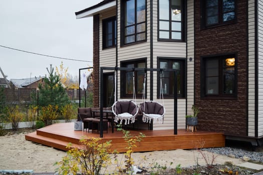 This charming modern house features a stylish deck that is perfect for relaxation and enjoying outdoor gatherings