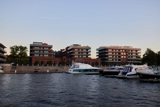 Elegant modern waterfront apartments set alongside exclusive luxurious yachts and tranquil serene water views