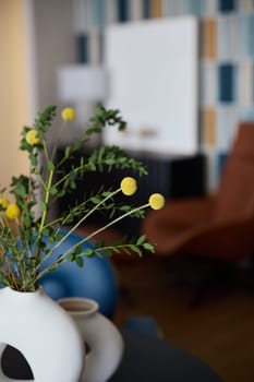 A contemporary living space that showcases a beautiful decorative vase alongside vibrant yellow flowers