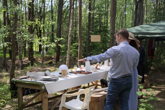 The serene outdoor dining setup among lush trees is ideal for gatherings and events that create lasting memories