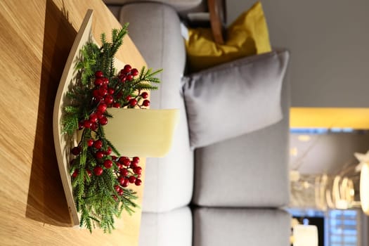 This is a beautifully styled living room showcasing a decorative arrangement that includes greenery and a candle