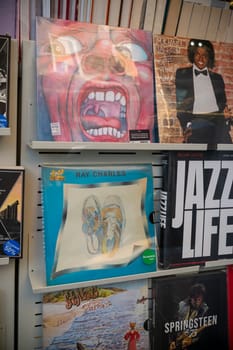 Cremona, Italy - November 27th 2024 Vinyl records by pink floyd. Michael jackson. Ray charles. Genesis. And a book about bruce springsteen are displayed on shelves in a record store
