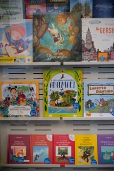 Cremona, Italy - November 27th 2024 Vibrant and engaging children's books are neatly arranged on a bookstore shelf, captivating young readers with their colorful covers and exciting titles