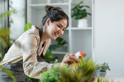 A young woman happily tending to her indoor garden, surrounded by vibrant plants in a stylish home setting.