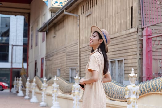 A young woman enjoys sightseeing in the city, taking in the urban architecture and cultural landmarks on a sunny day.