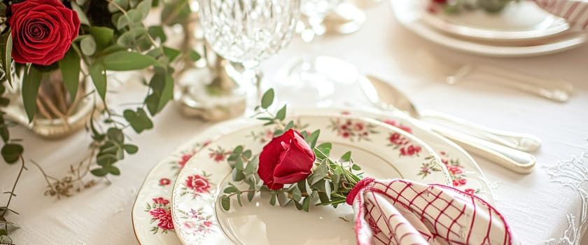Festive table setting with candles and arrangement of beautiful red flowers. Holiday concept. High quality photo