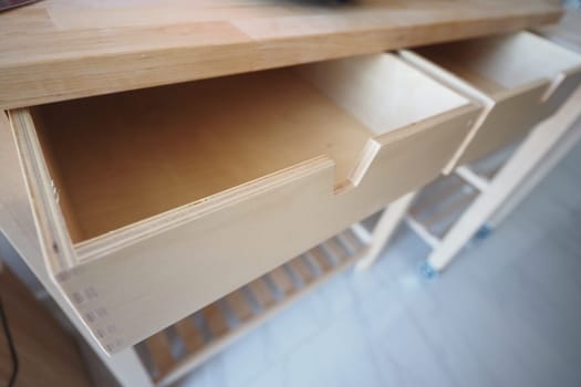 The empty wooden kitchen drawers showcase beautiful, clean design with style and efficiency