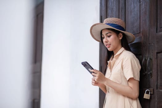 Young woman enjoying city life, walking with style and confidence, embracing urban fashion and technology.