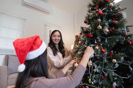 A young woman in love decorates her room for Christmas, creating a festive and joyful atmosphere.