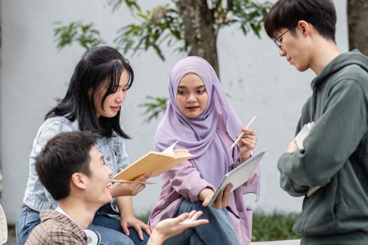 A diverse group of students gathers outdoors, collaborating and studying together for an upcoming exam. They are engaged and focused on their study materials.