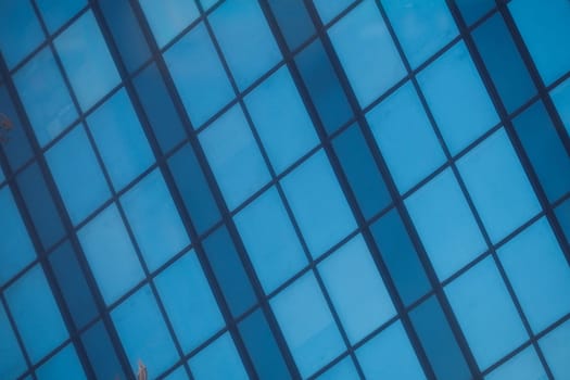 A modern and sleek facade of a contemporary office building showcasing large glass windows