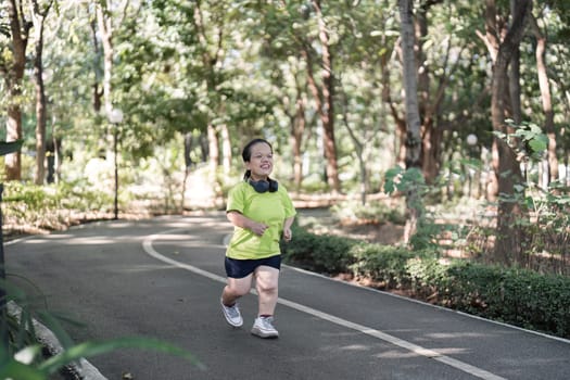 A woman jogs through a tranquil garden, enjoying the fresh air and natural surroundings.
