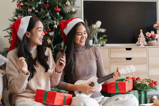 A young couple enjoys a cozy Christmas party at home, surrounded by festive decorations and gifts.