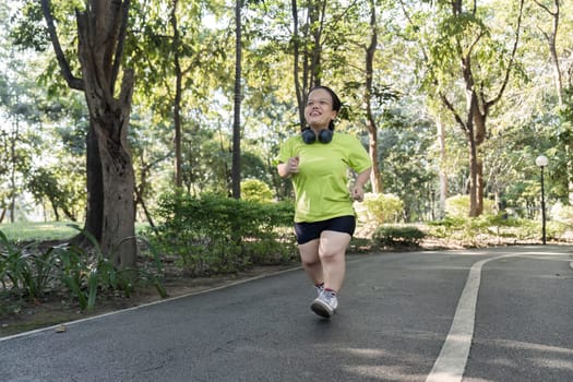 A woman enjoys a refreshing jog through a vibrant garden, surrounded by lush greenery and sunlight.