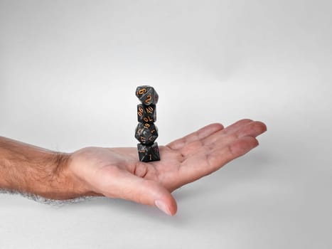 Balanced polyhedral dice in hand. Symbol of strategy and chance in modern gaming culture.