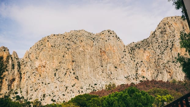 The rocky cliffs are surrounded by lush greenery, showcasing natures remarkable beauty for all to admire