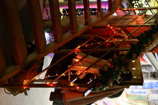 A beautifully decorated staircase adorned with warm lights and festive garland, creating the perfect holiday ambiance