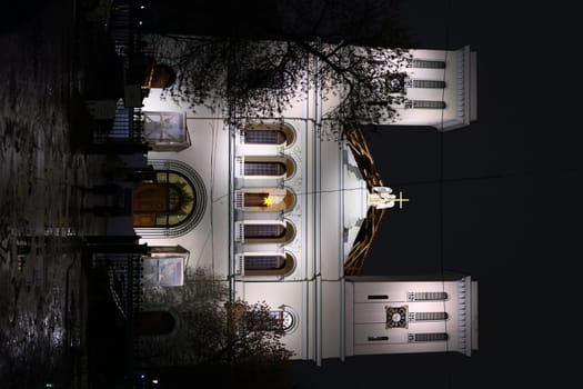 A stunning church beautifully lit at night, showcasing its architectural details against a dark sky.