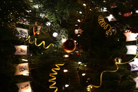 A beautifully decorated Christmas tree, beautifully adorned with vibrant lights, unique ornaments, and festive ribbons