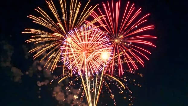 Golden and colorful fireworks with shimmering trails explode against a dark sky, capturing the excitement of festive celebrations.