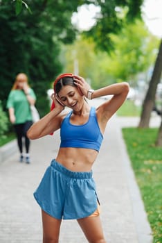 A young woman can be seen exercising outdoors on a beautiful day, radiating positivity, happiness, and vitality