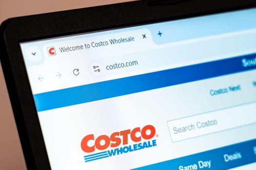 New York, USA - December 21, 2024: Costco Wholesale website homepage displayed on laptop screen with logo. Retail company offering bulk groceries, electronics, furniture, and membership services