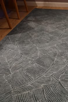 This trendy green area rug, featuring intricate patterns, greatly enhances the modern home decor aesthetics beautifully