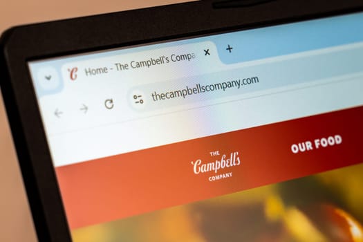 New York, USA - December 21, 2024: Campbell's website homepage displayed on laptop screen with logo. Iconic American food company offering soups, sauces, snacks, and beverages
