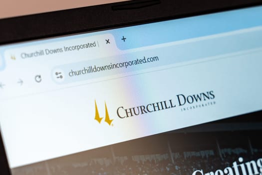 New York, USA - December 21, 2024: Churchill Downs Incorporated website homepage displayed on laptop screen with logo. Operator of horse racing tracks, casinos, and online betting platforms