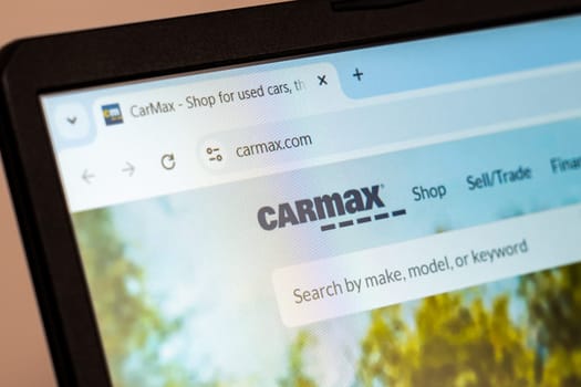 New York, USA - December 21, 2024: CarMax website homepage displayed on laptop screen with logo. Retailer specializing in used cars, trade-ins, and financing options
