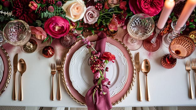 Festive table setting with candles and arrangement of beautiful red flowers. Holiday concept. High quality photo