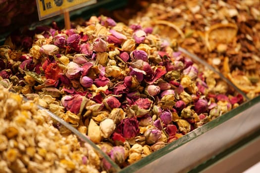 At a bustling market, discover vibrant dried rose petals and herbs, beautifully arranged