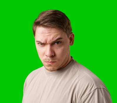 Intense expression captured against a bright green background in a studio