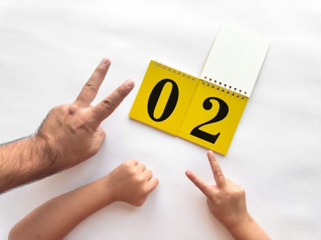 Creative countdown with hands and calendar on white background.