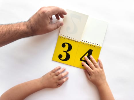 Intergenerational learning with a calendar featuring bold numbers.