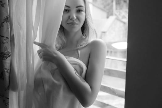 Portrait of a Sexy Girl Hiding Her Body Behind a Curtain in a Hotel .Romantic Date with a Mistress.