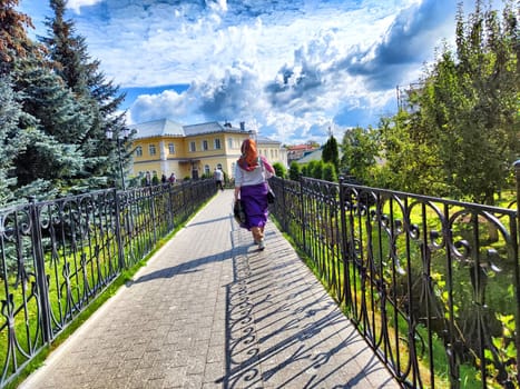 People walk and pray along paved path within the grounds of the Diveevo Monastery, Russia