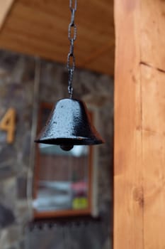 old bell on the facade of the house. The exterior of the building and design details are vintage